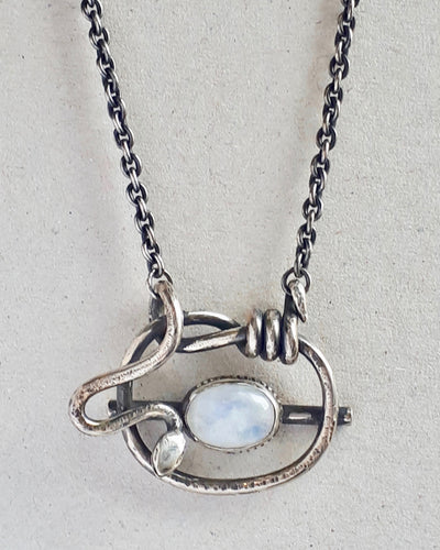 Close up of a sterling silver necklace featuring a moonstone.