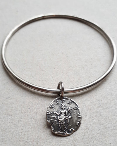 Oxidized sterling silver Immortal bangle featuring a Equitas, goddess of equality and honour.