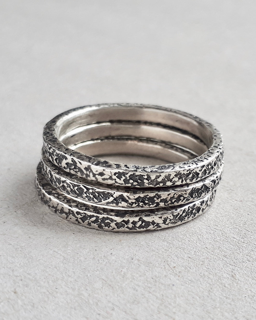 Stack of three sterling silver concrete textured rings.