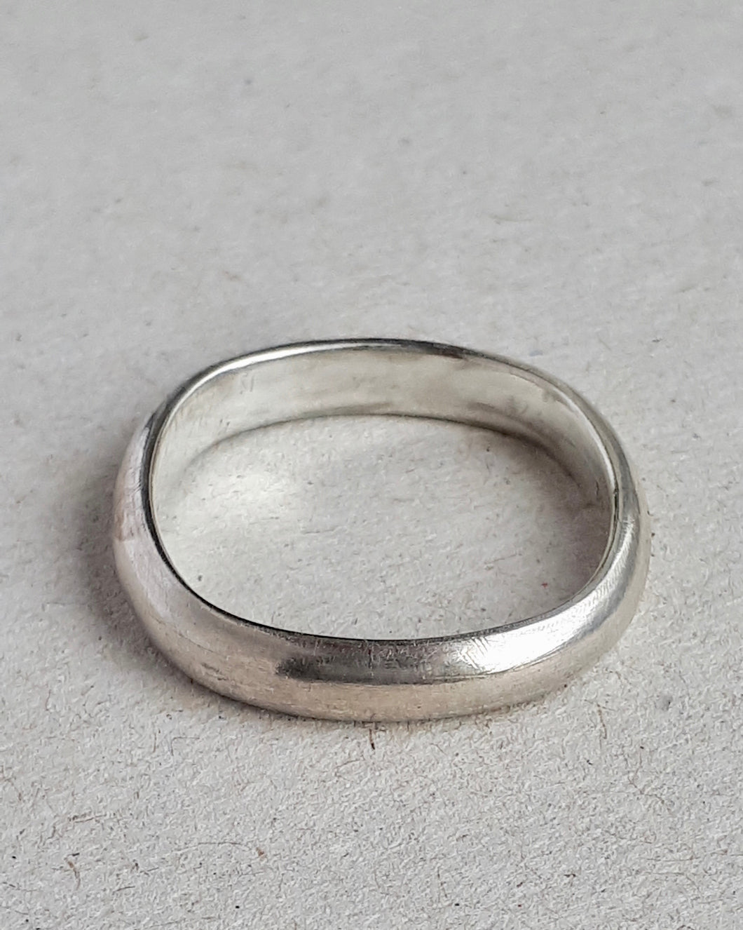 Front view of a soft square sterling silver ring.